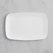 A white rectangular Visions plastic plate on a marble surface.