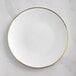 A white Visions plastic coupe plate with a gold rim.