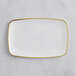 A white rectangular plastic plate with a gold border.
