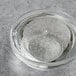 A clear glass bowl with clear Tapioca syrup in it on a counter.