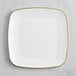 A Visions white square plastic plate with gold trim.