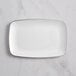 A white rectangular plastic plate with a silver trim.