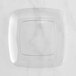 A clear square plate with a white circle.