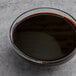 A bowl of Malt Products CaneRite Premium Molasses on a table.