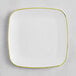 A Visions white square plastic plate with a gold rim.