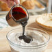 A person pouring CaneRite Organic Blackstrap Molasses into a bowl of flour.