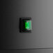 A close up of the green LED lighting on a black Avantco dry bakery display case.