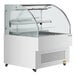 An Avantco white horizontal air curtain merchandiser with a glass door.