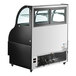 An Avantco black curved dual service air curtain merchandiser with a glass door.