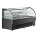 An Avantco black horizontal air curtain merchandiser with a clear glass top on a counter.