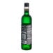 A close up of a bottle of DaVinci Gourmet Classic Green Apple fruit syrup with green liquid inside.