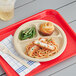 A Tellus Products natural bagasse 3-compartment plate with spaghetti and a drink on a tray.