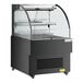 An Avantco black horizontal air curtain merchandiser with LED lighting and a glass shelf.