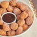 A bowl of Revel Eats Horchata Bites with chocolate dipping sauce.