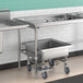 A Regency stainless steel sorting table with a stainless steel sink and two bowls on wheels.