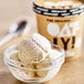 A bowl of Oatly vanilla oat milk ice cream with a spoon.