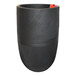 A black round planter with orange trim on the side.