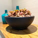 A Floridis Amsterdam round black planter bowl with plants in it.