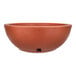 A brown round bowl with a handle on it.