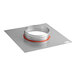 A round metal plate adapter with a red band on it.