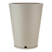 A round beige planter with a white base.