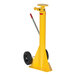 A yellow Vestil portable trailer stabilizing jack with black wheels and a red handle.