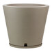 A Floridis round beige planter with a white rim.