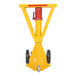 A yellow and red Vestil hydraulic trailer stabilizing ratchet jack with wheels.