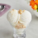 A glass bowl of Lloyd's of Pennsylvania Hazelnut Hard Serve Ice Cream with nuts on top.