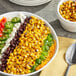 A bowl of Sevillo Fine Foods fire grilled corn with jalapeno peppers.