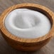 A bowl of Sunglo white popcorn salt on a table.