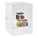 A 15" x 15" x 21" clear acrylic countertop display case with different bottles of liquor on each shelf.