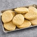 A tray of Gardein plant-based breaded chick'n breast filets on a metal tray.