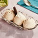 A bowl of Lloyd's of Pennsylvania Cookies and Cream ice cream with a spoon.