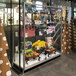 A 70" x 20" x 72" glass display showcase with toys on shelves.