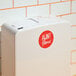 A white Aunt Flow touch-free sanitary napkin and tampon disposal unit box with a red logo.