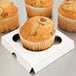 A group of three muffins in a white Baker's Lane cupcake insert.