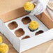 A white cupcake insert for a 10-inch by 10-inch box, designed to hold six standard cupcakes.