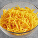 A bowl of Daiya Vegan Shredded Sharp Cheddar Cheese.