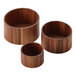 A group of American Metalcraft acacia wood risers on a table.