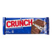 A close up of a CRUNCH® chocolate bar with nuts in a blue wrapper.