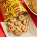 A snack pack of Keebler Fudge Stripes Minis cookies, with several round, striped cookies spilled onto a napkin.