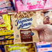 A hand holding a bag of Famous Amos chocolate chip cookies.