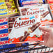 A hand holding a package of KINDER Bueno King Size Hazelnut Milk Chocolate Bars.