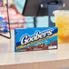 A box of GOOBERS milk chocolate-covered peanuts on a table.