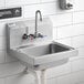 A Regency stainless steel wall-mounted hand sink with T&S faucet above it.