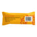 A yellow package with red text and a bar of chocolate.