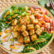 A bowl of rice and vegetables with close-up cubes of Nasoya Organic Baked Tofu.