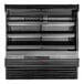 A black Howard McCray vertical open air curtain produce merchandiser with shelves.