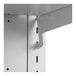 A white metal shelf with holes.